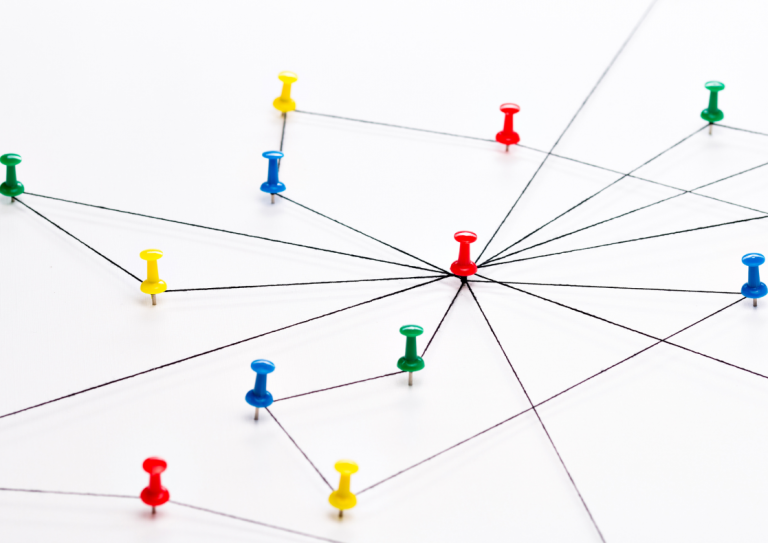 Multiple brightly coloured pins connected by multi coloured thread