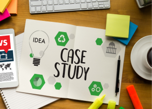 Piece of paper on a desk stating cae study, surrounding by colourful sticky notes and highlighter pens